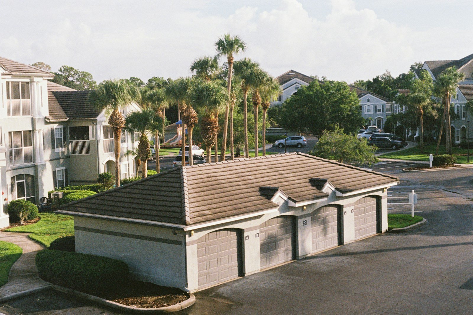 A view of a street with houses and palm trees